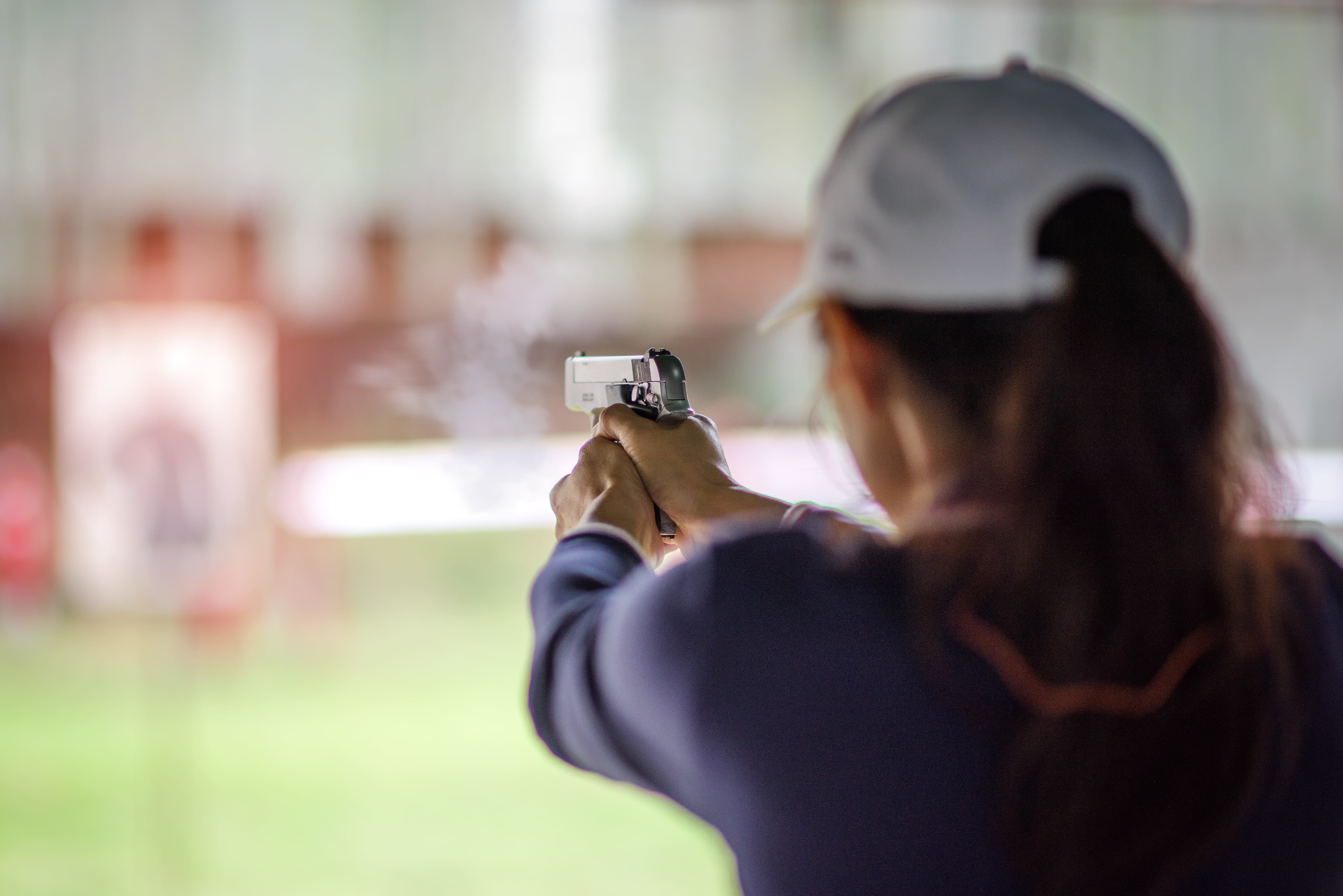 woman holding a handgun at gun range for License To Carry